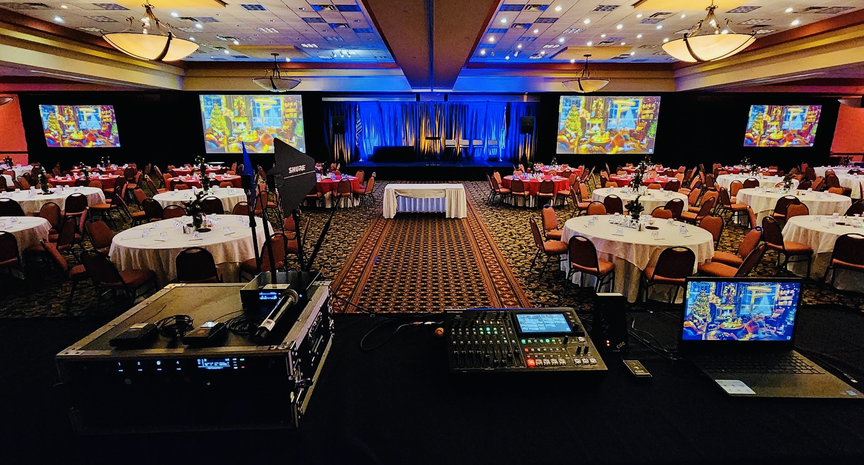 Corporate ballroom event with multiple projection screens and production control