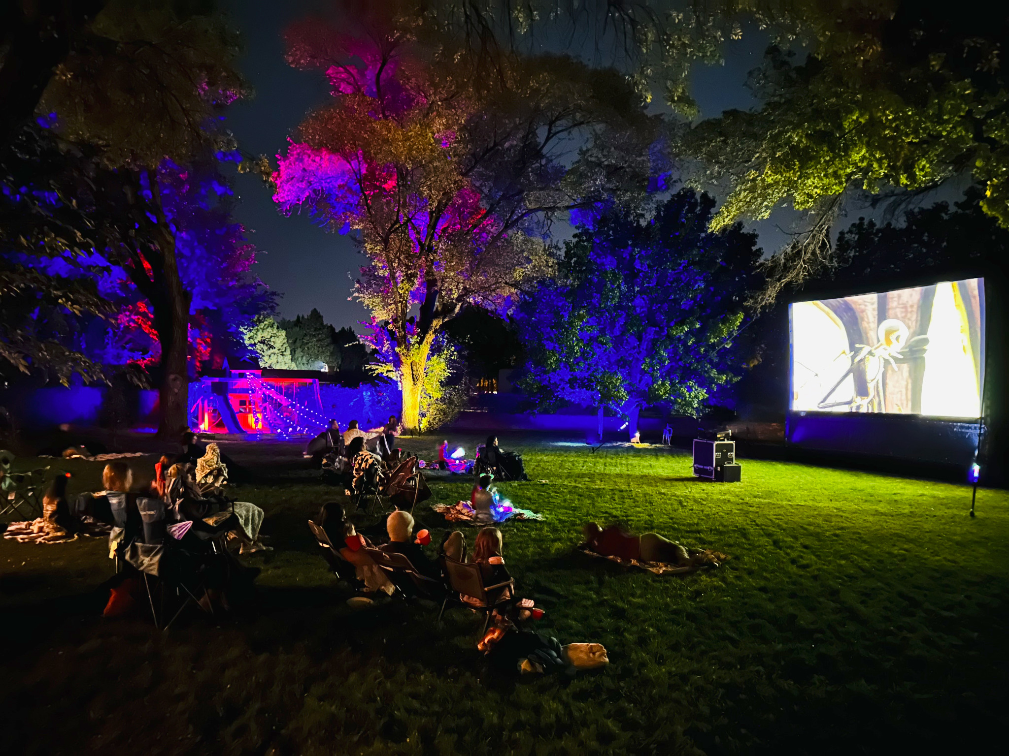 Outdoor cinema event with projection and architectural lighting